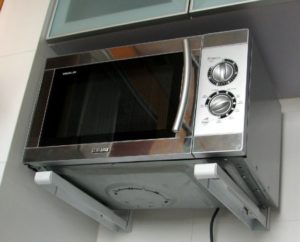 Microwave on brackets attached to the wall