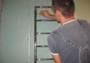 At what height should you hang a heated towel rail in the bathroom?