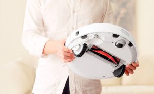 Robot vacuum cleaner in hands