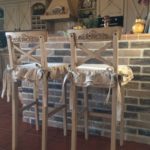 Bar stool cover made of fabric.