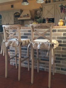 Bar stool cover made of fabric.