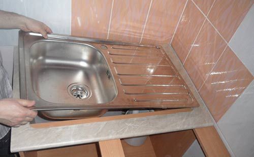 How to install a stainless steel sink on a cabinet.
