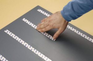 Attaching the mirror using mounting tape.