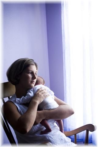 Mom and baby in a rocking chair.