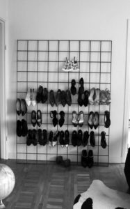 Wall stand for hanging shoes by their heels.
