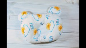 Pillow for a newborn in the shape of a bear.
