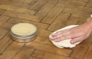 We wax the floor to move the cabinet.