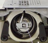 Swinging shuttle in a sewing machine