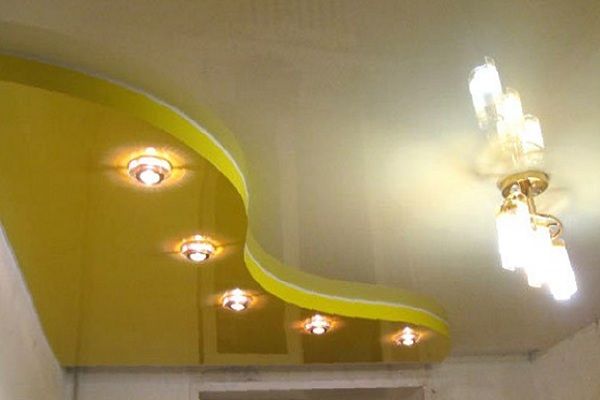 Stretch ceiling with two chandeliers.