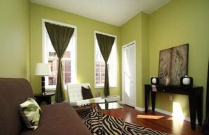 Green curtains in the bedroom interior