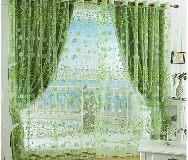 Green curtains in the bedroom interior