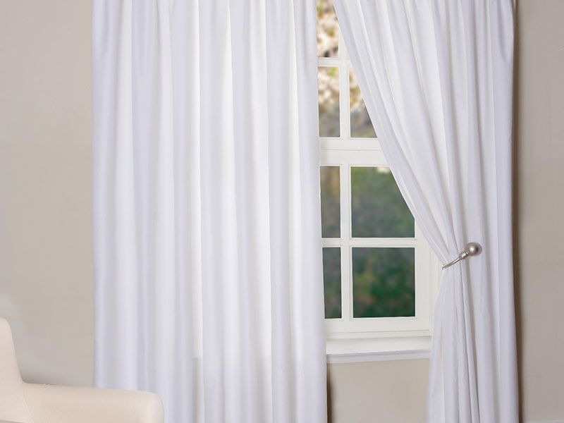 White curtains in the bedroom interior