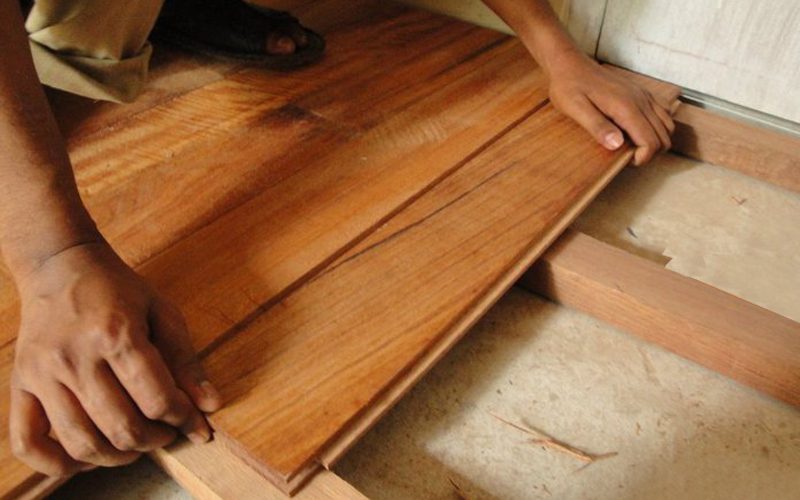 Laying solid boards on joists.