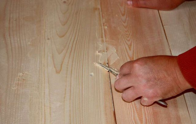 Sealing cracks in laminate flooring.