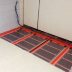 Infrared heated floor under laminate