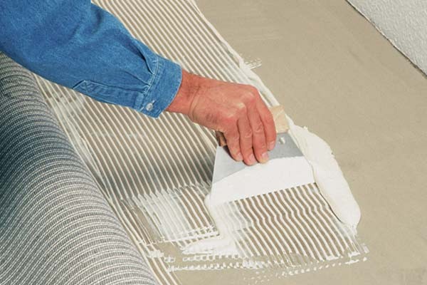 Laying carpet with glue.