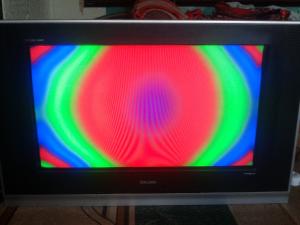 Colored spots on the TV screen.