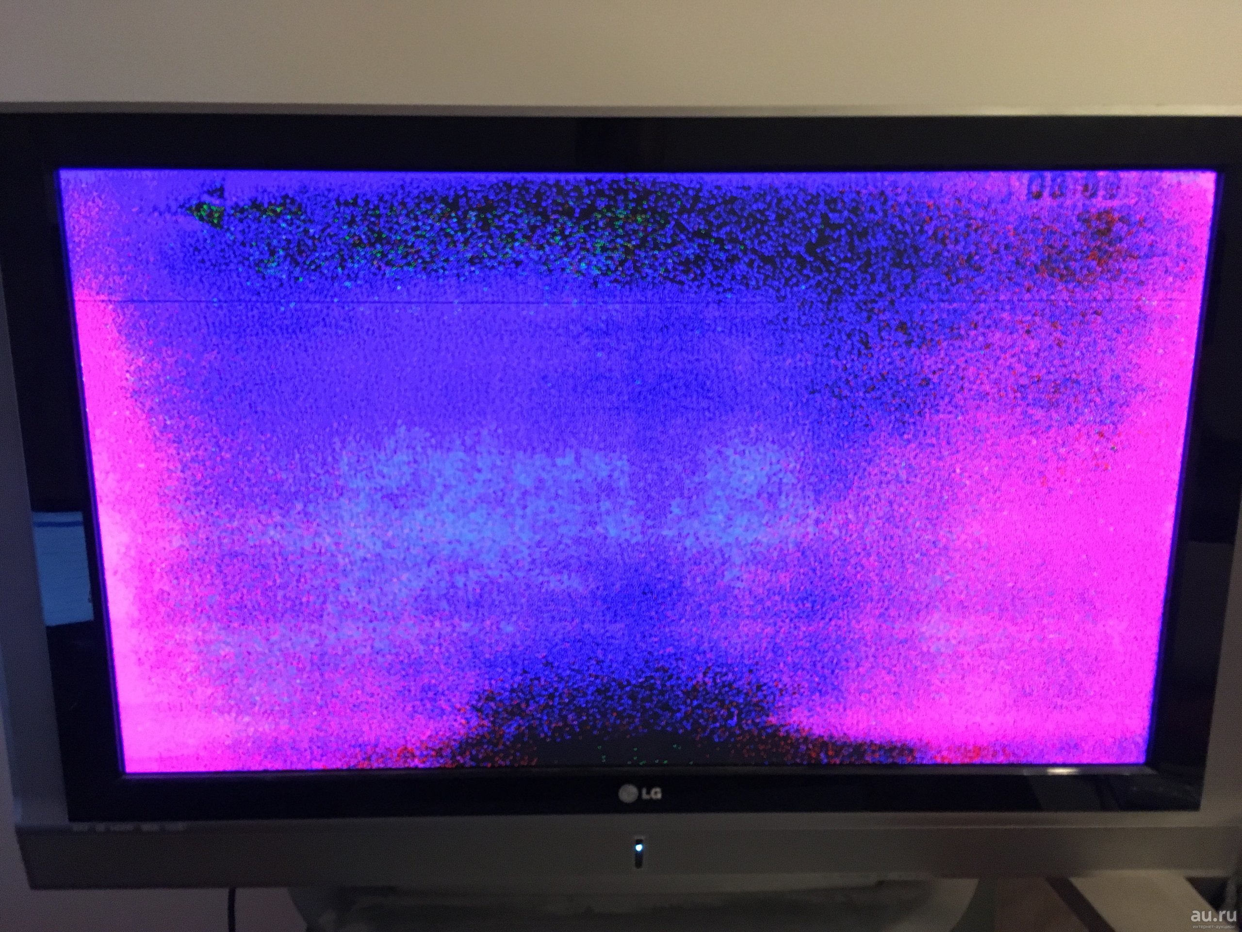 Colored spots on the screen of a modern TV.
