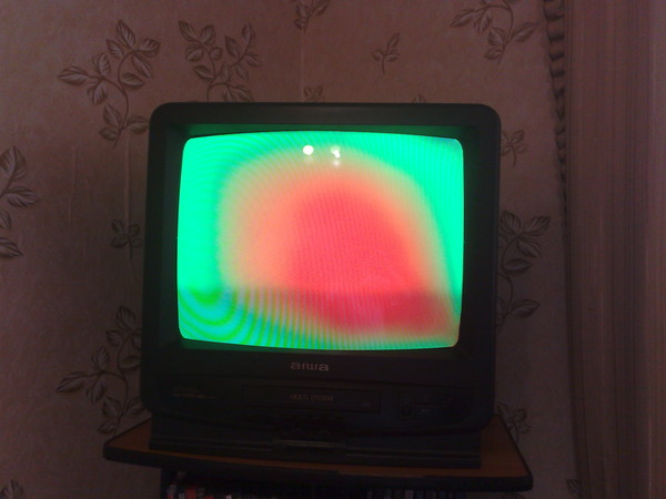 Colored spots on the CRT TV screen.