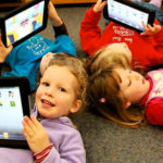 Children play on a tablet.