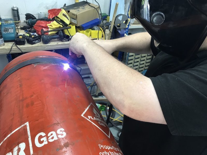 Making the base of a smokehouse from a gas cylinder.