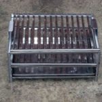 Homemade smokehouse with grate.