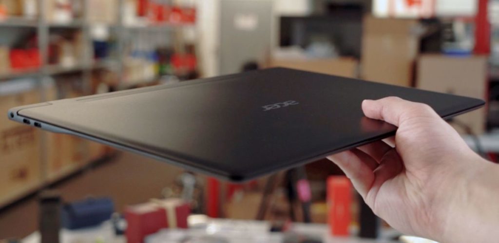 A thin laptop from Acer in hand.