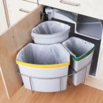 Several trash cans in the kitchen.