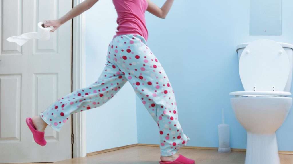 A man runs to the toilet.