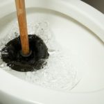 Cleaning with a plunger.