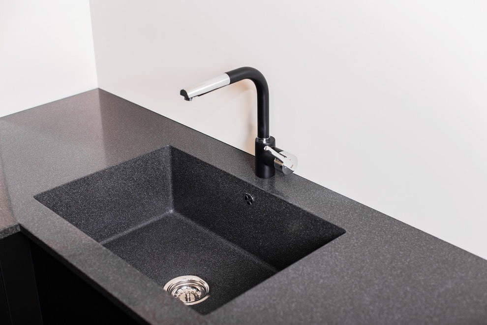 Black sink made of artificial stone.
