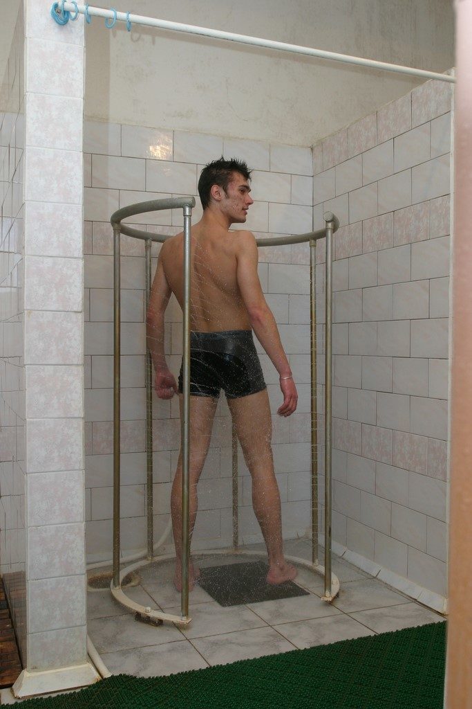 A man takes a circular shower.