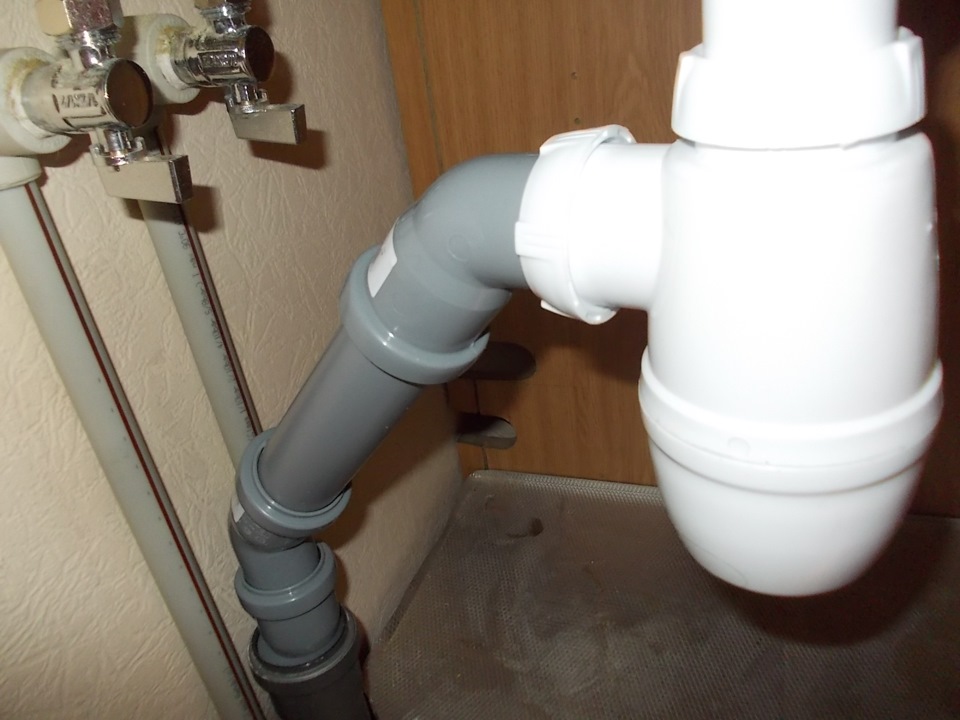 Bottle siphon under the sink.