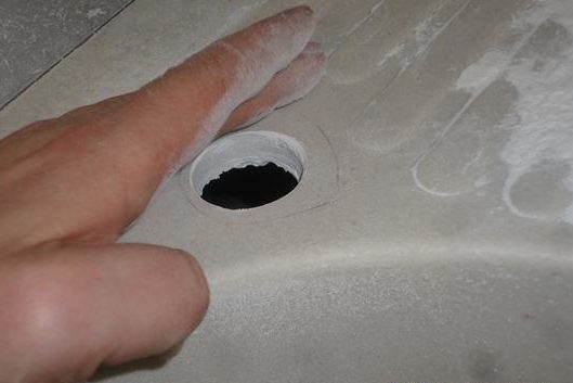 Drilled hole for faucet.