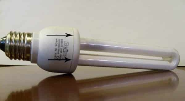 Testing an energy-saving lamp with a multimeter.