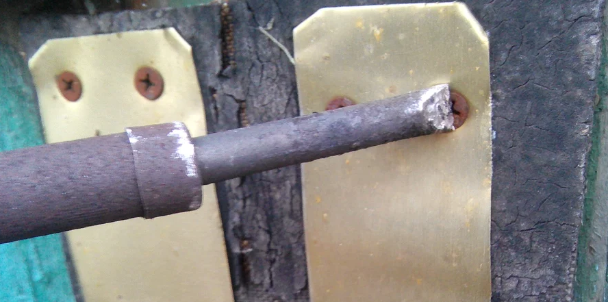 Warming up the screw with a soldering iron