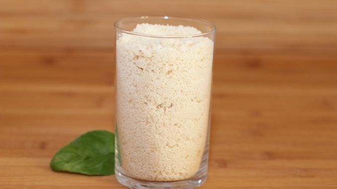 measuring flour with a glass