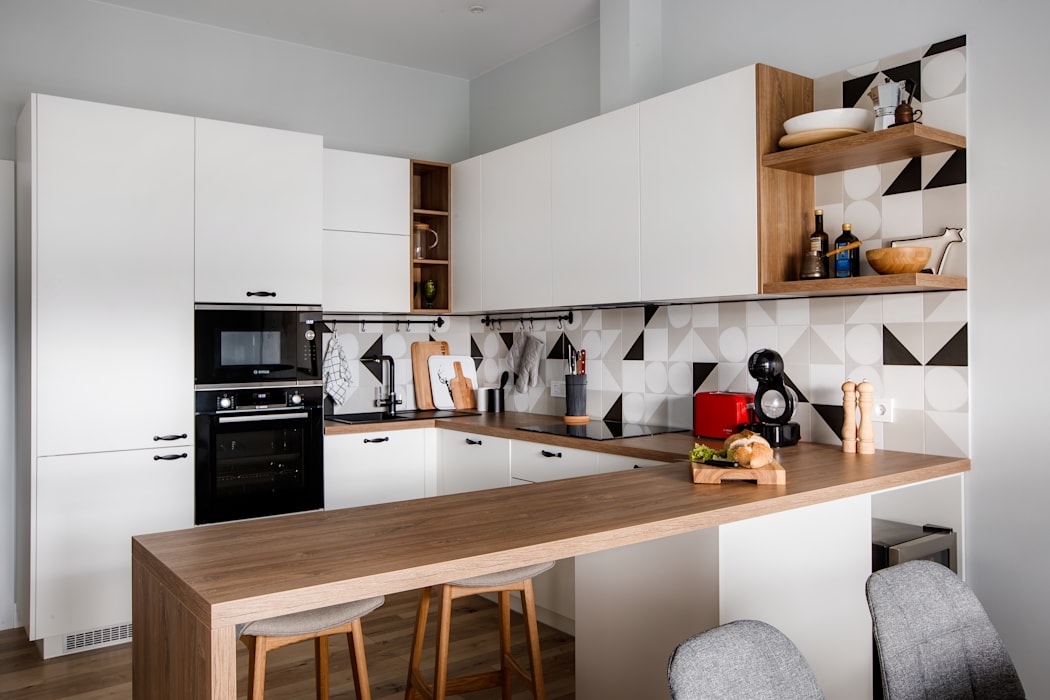 Wooden countertop and ceramic splashback in a Scandinavian style kitchen