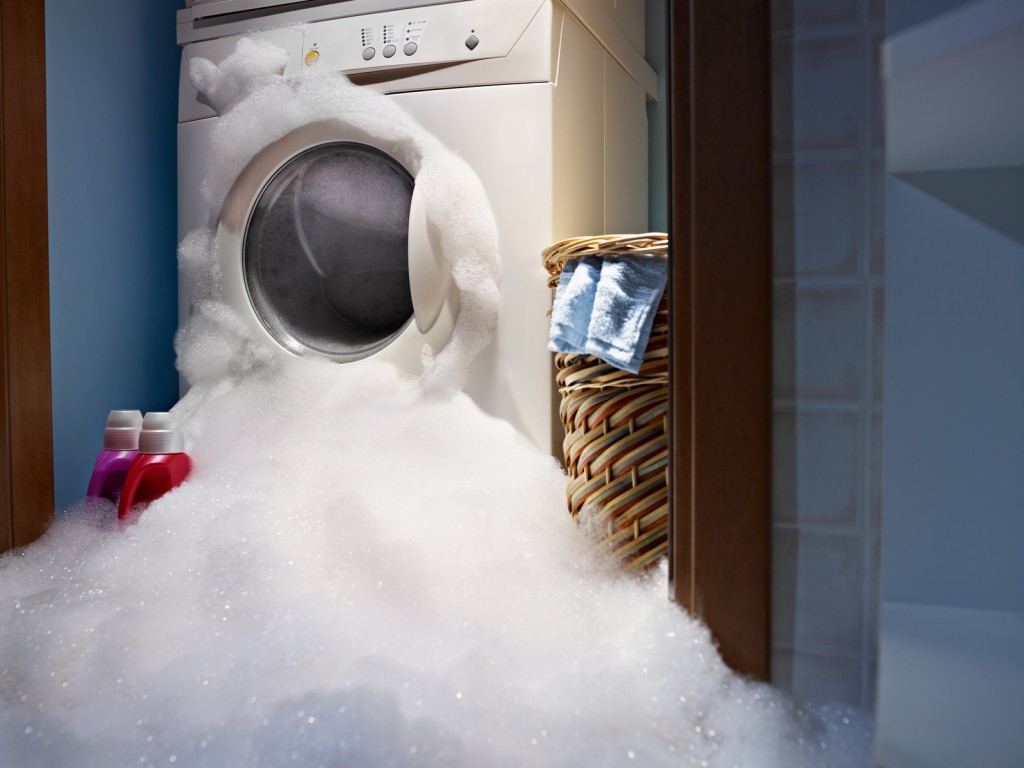 Foam pours out of the washing machine