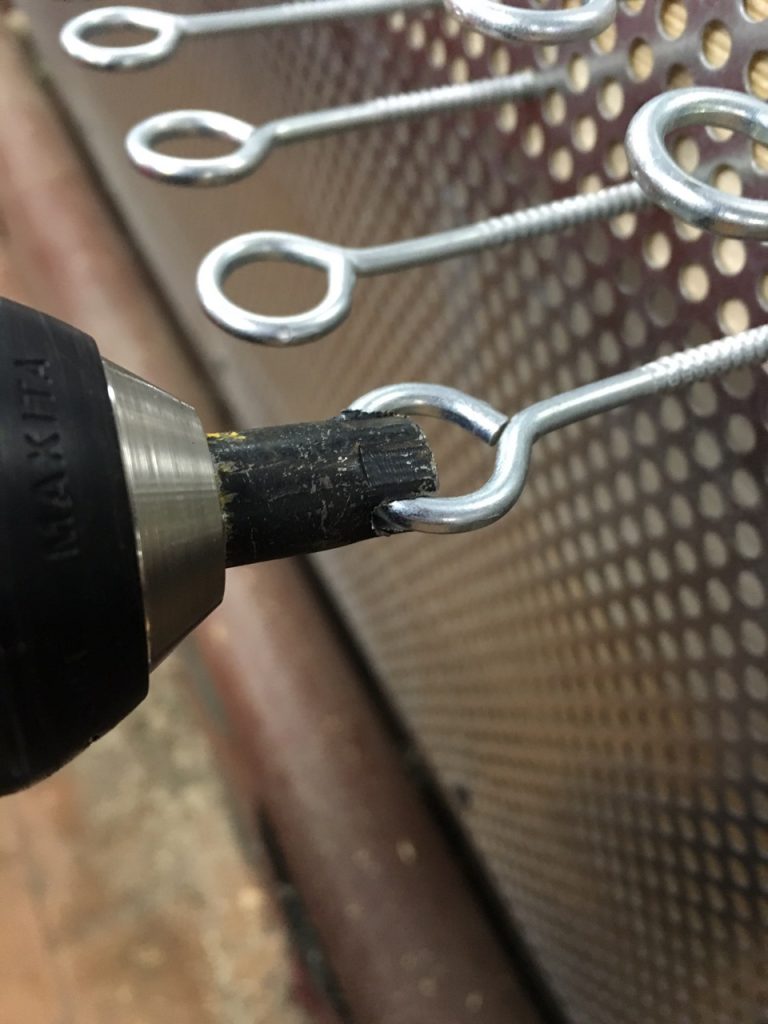 screwing in hooks with a screwdriver