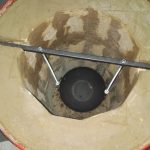 Cooking meat in a tandoor from a barrel.