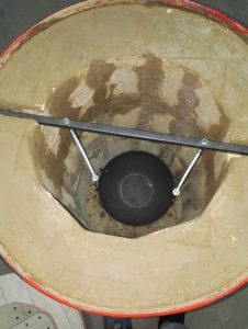 Cooking meat in a tandoor from a barrel.