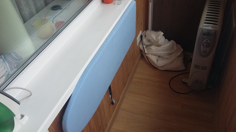 Storing an ironing board on the loggia