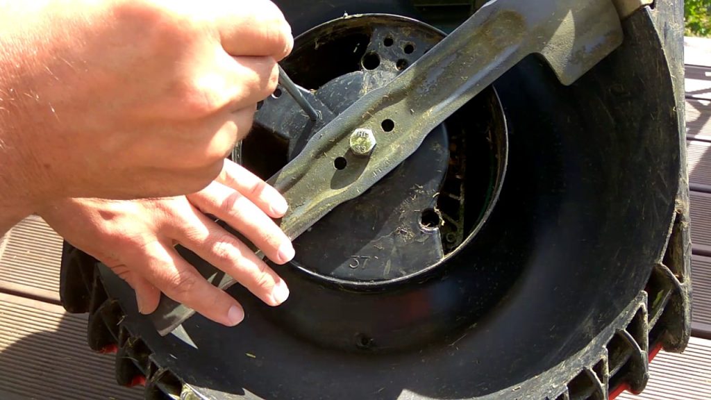 Removing the lawn mower blade.