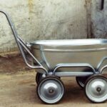 A wheelbarrow made from a trough on four wheels.