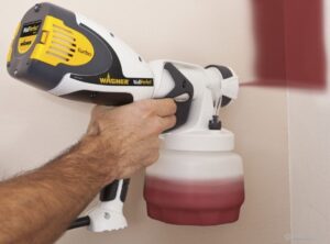 Painting a house with a spray gun