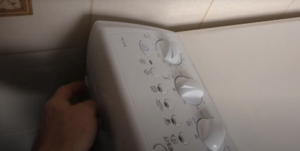 unscrew the 2 screws under the panel