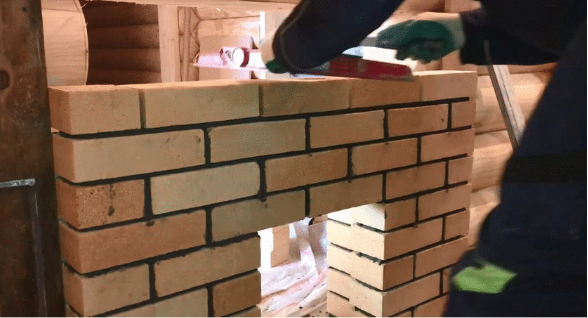 Stove in a bathhouse on a wooden floor 11