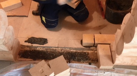 Stove in a bathhouse on a wooden floor 9