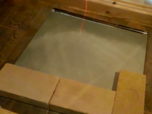 Stove in a bathhouse on a wooden floor 5